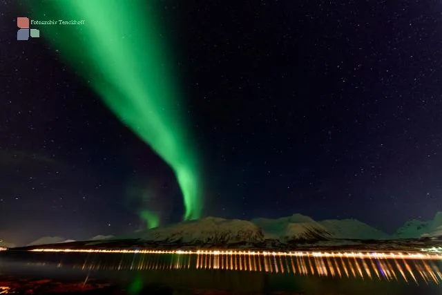 Northern lights over the Solenagen fjord in front of the Lyngenfjord Alps